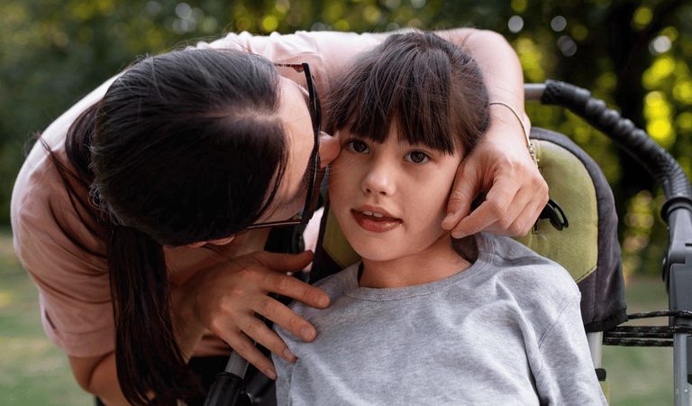 Girl with mum in wheelchair assistance accessibility1920w x 900h px